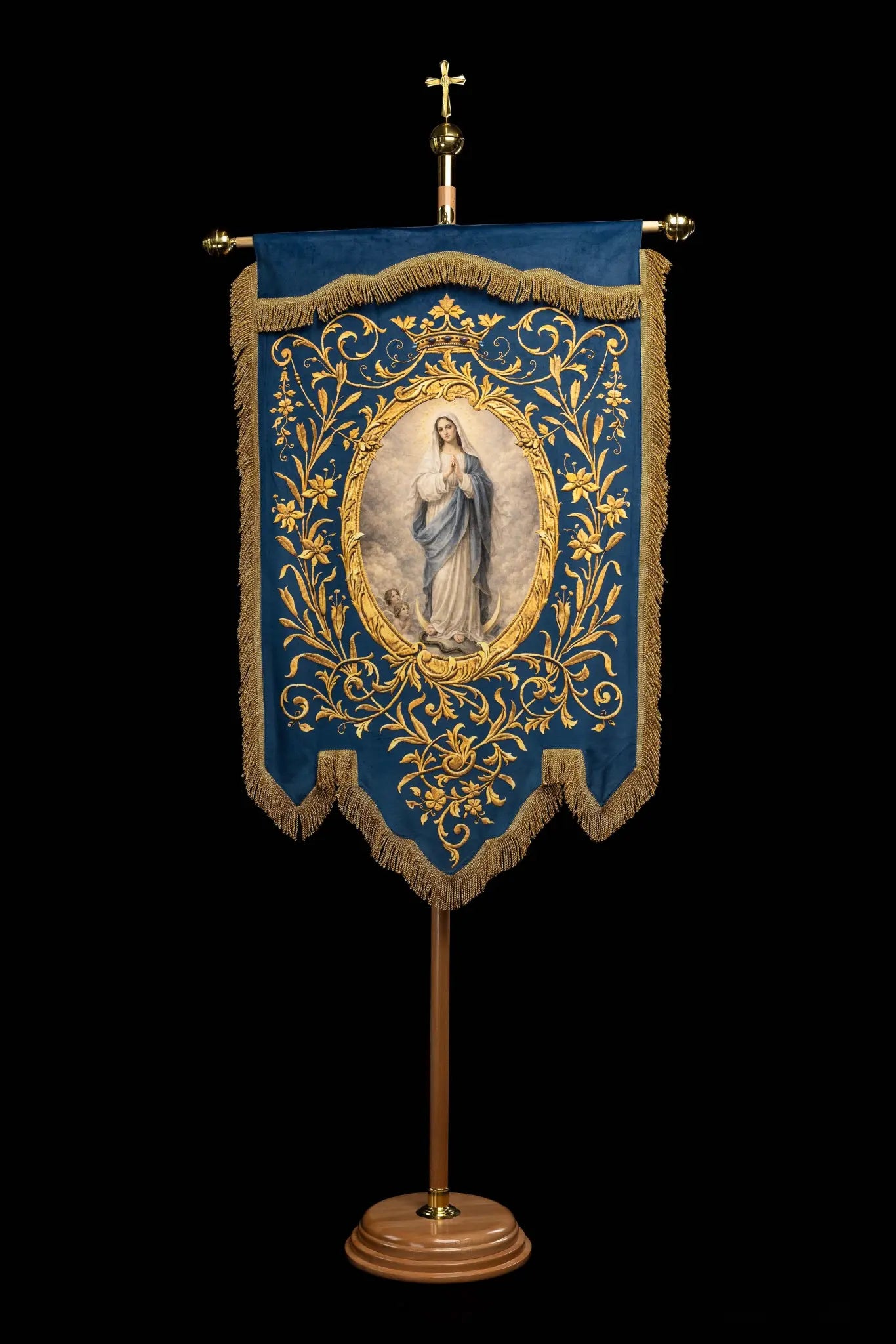 Double-sided blue processional banner with an image of Our Lady of the Immaculate Conception on one side and a Marian monogram on the other, both surrounded by gold floral ornamentation and finished with gold fringes.