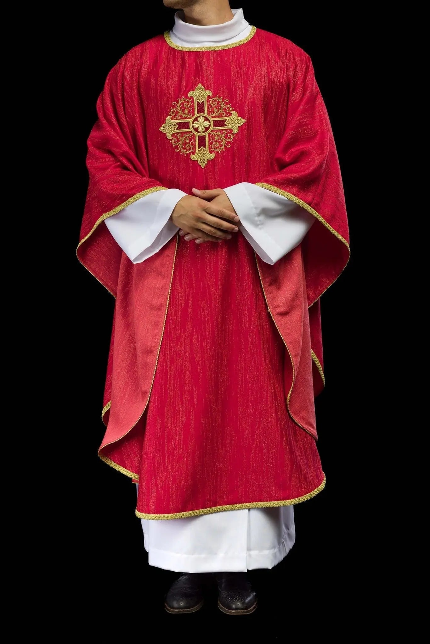 Red chasuble with embroidered cross motif on decorative fabric