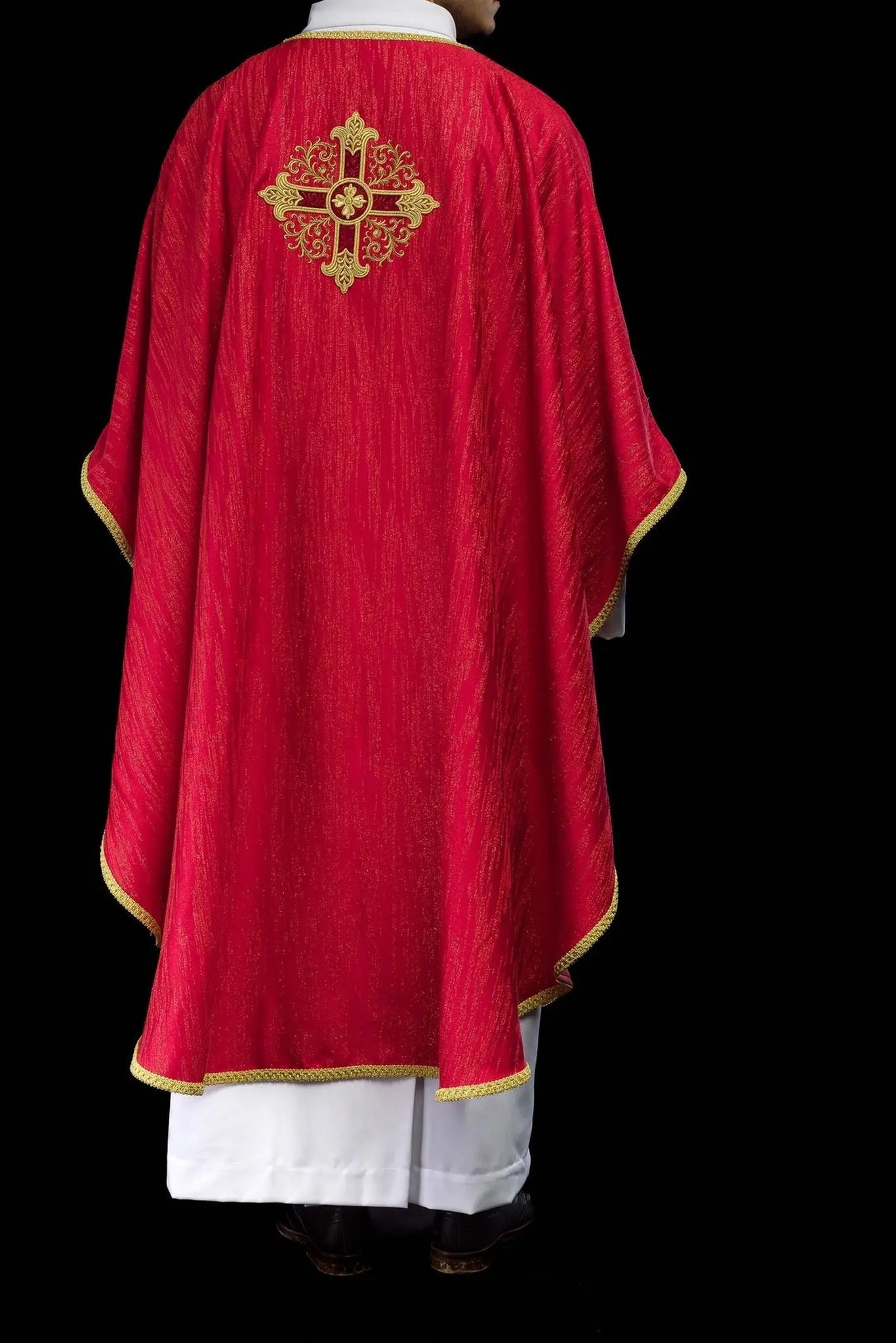 Red chasuble with embroidered cross motif on decorative fabric