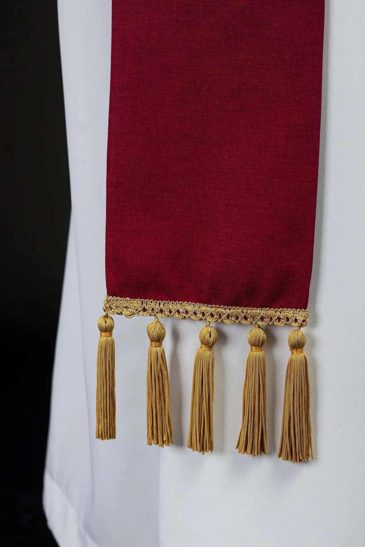 Red stole embroidered with the IHS motif