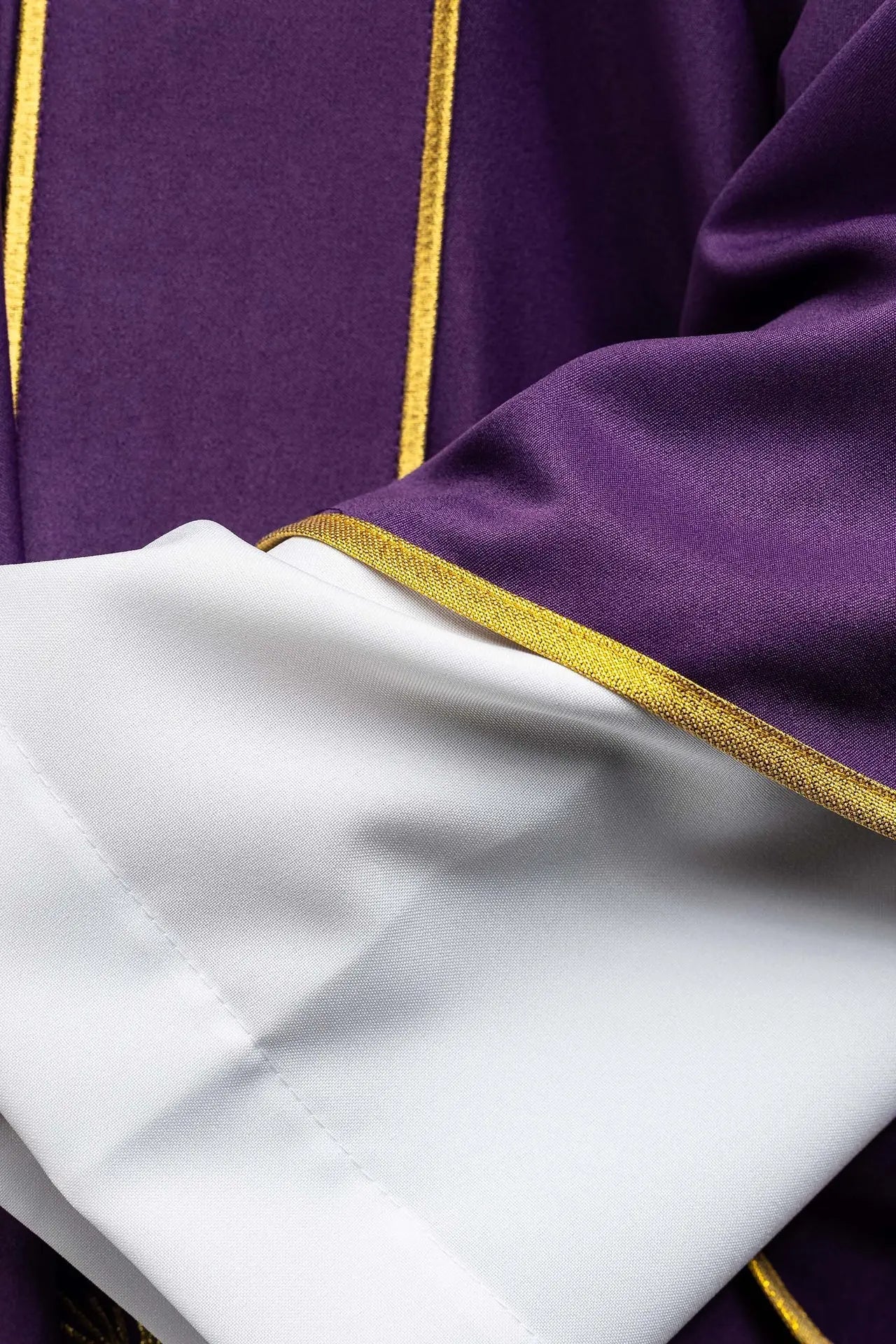 Dalmatique violette avec bandes décoratives et broderie de croix dorée