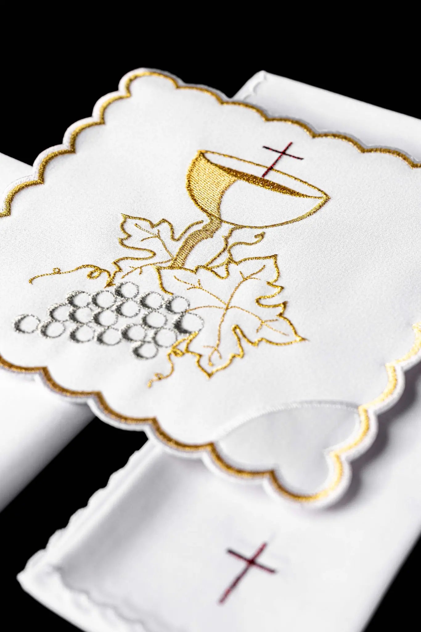 White chalice linen set with IHS monogram embroidery on the pall and cross embroidery on the purificator and lavabo towel.