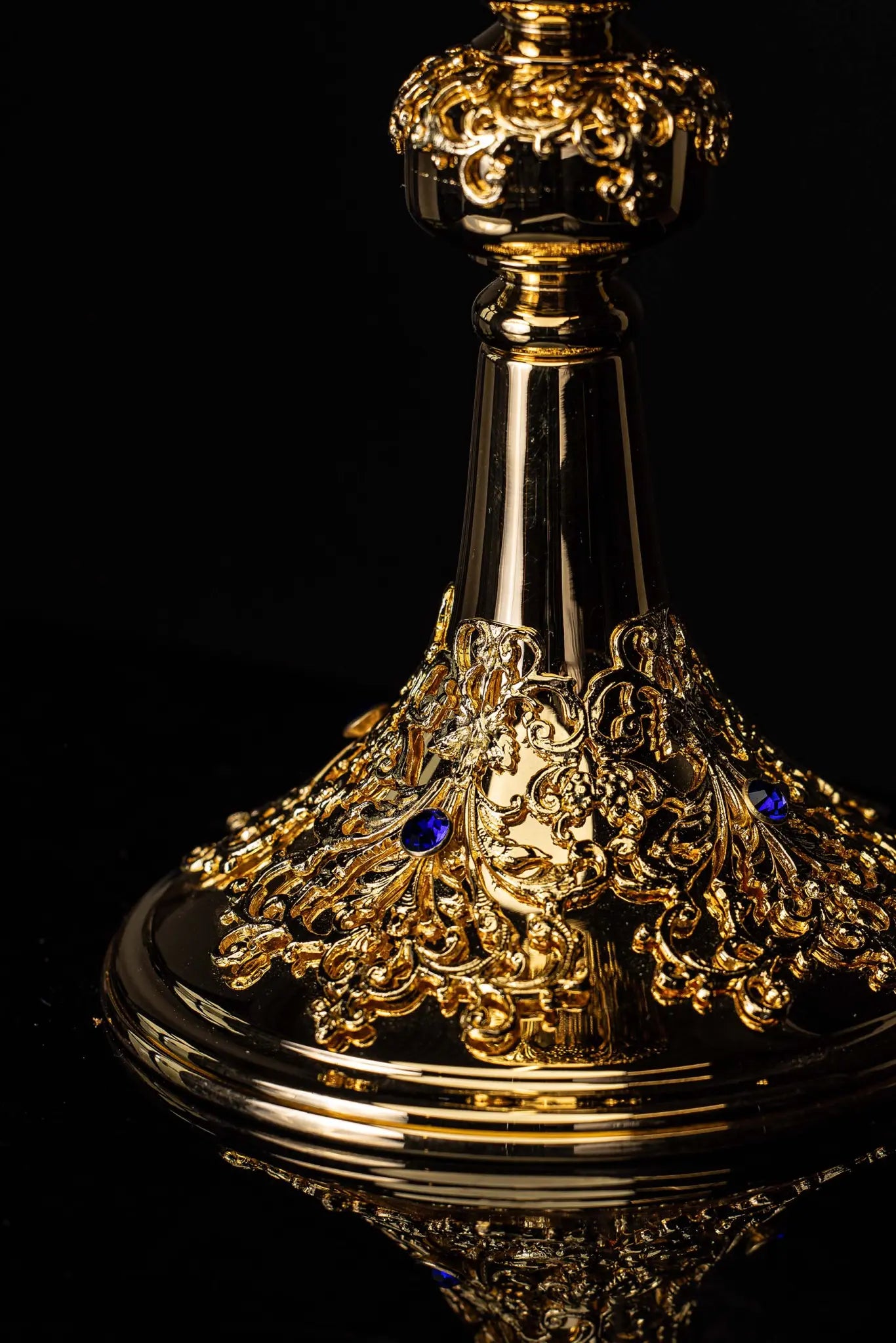 Handmade gold-plated ciborium with floral ornamentation and blue imitation sapphires, topped with a cross.