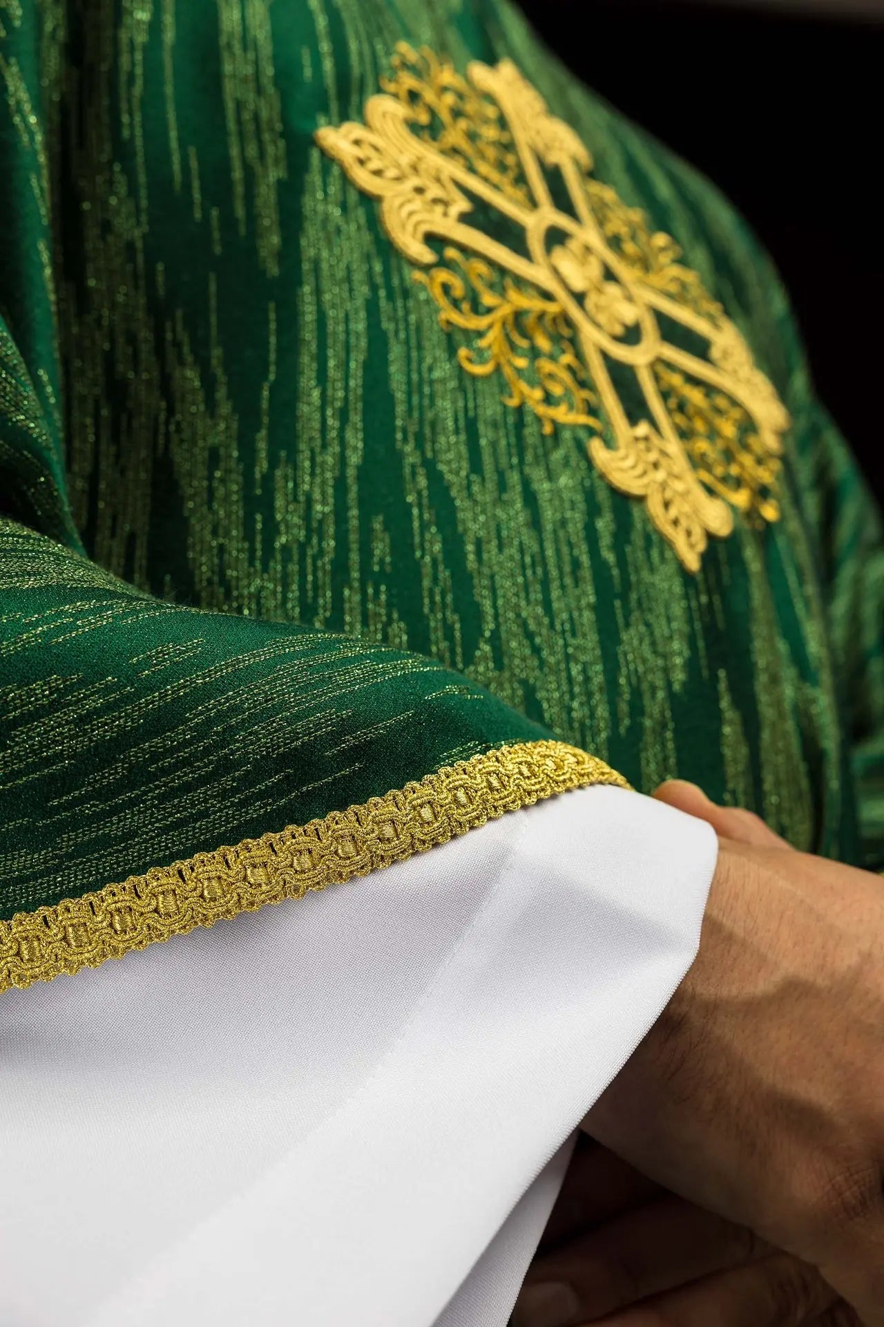 Green chasuble with an embroidered cross motif on decorative fabric