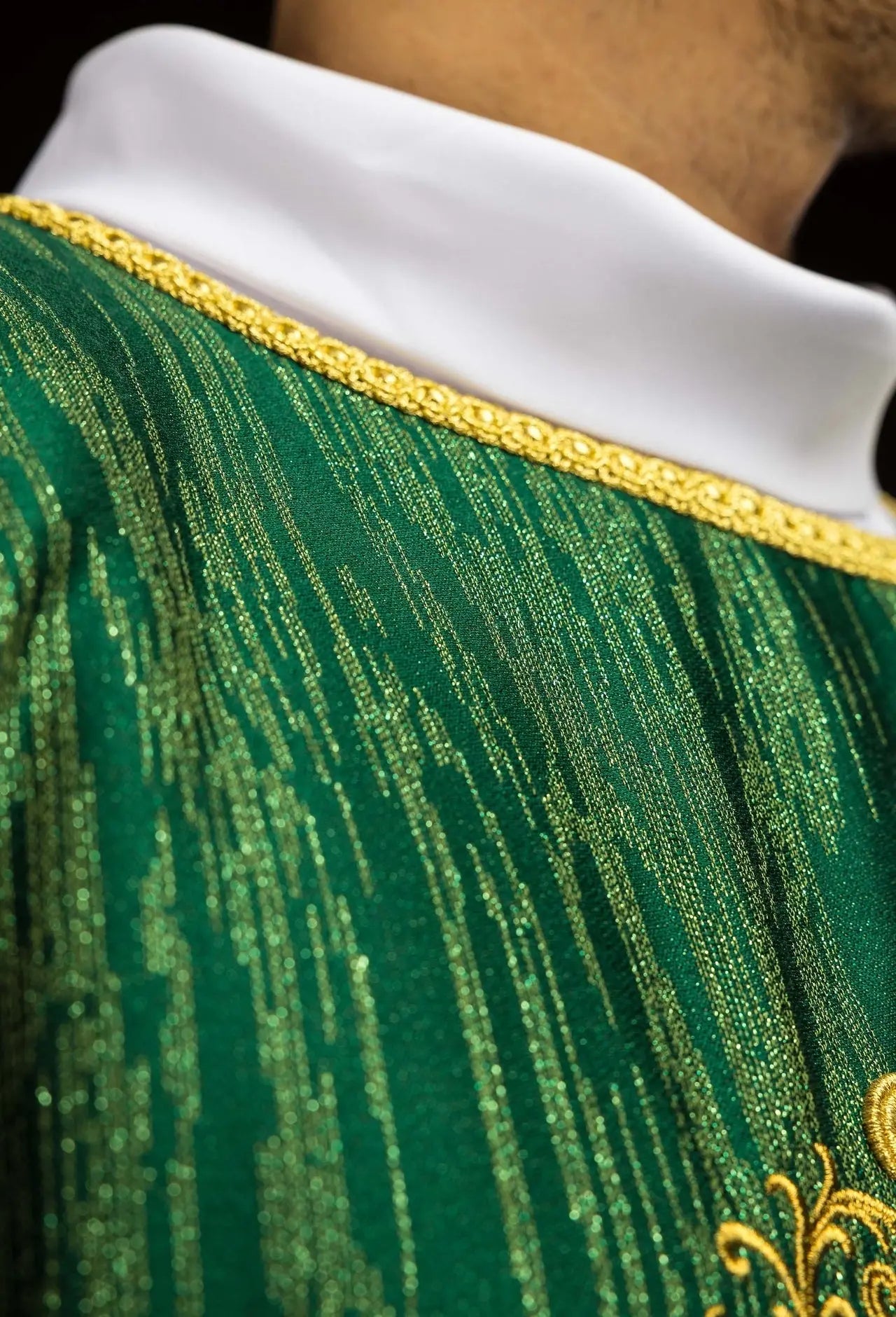 Green chasuble with an embroidered cross motif on decorative fabric