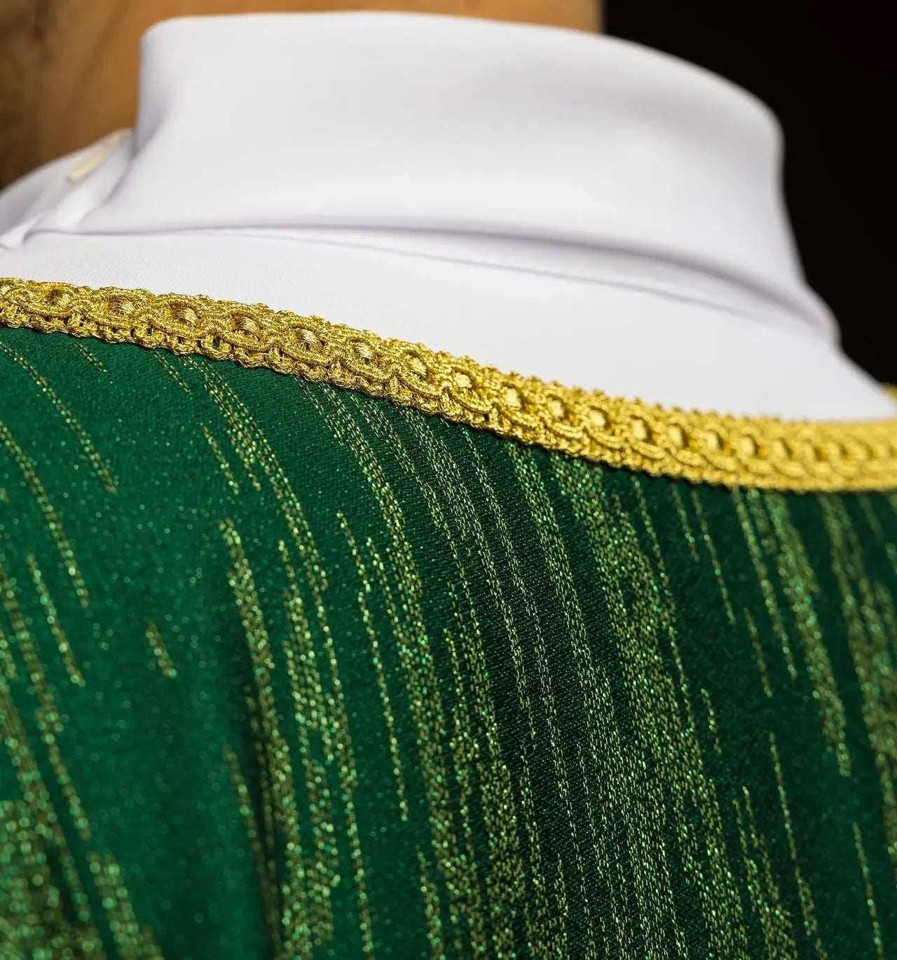 Green chasuble with an embroidered cross motif on decorative fabric
