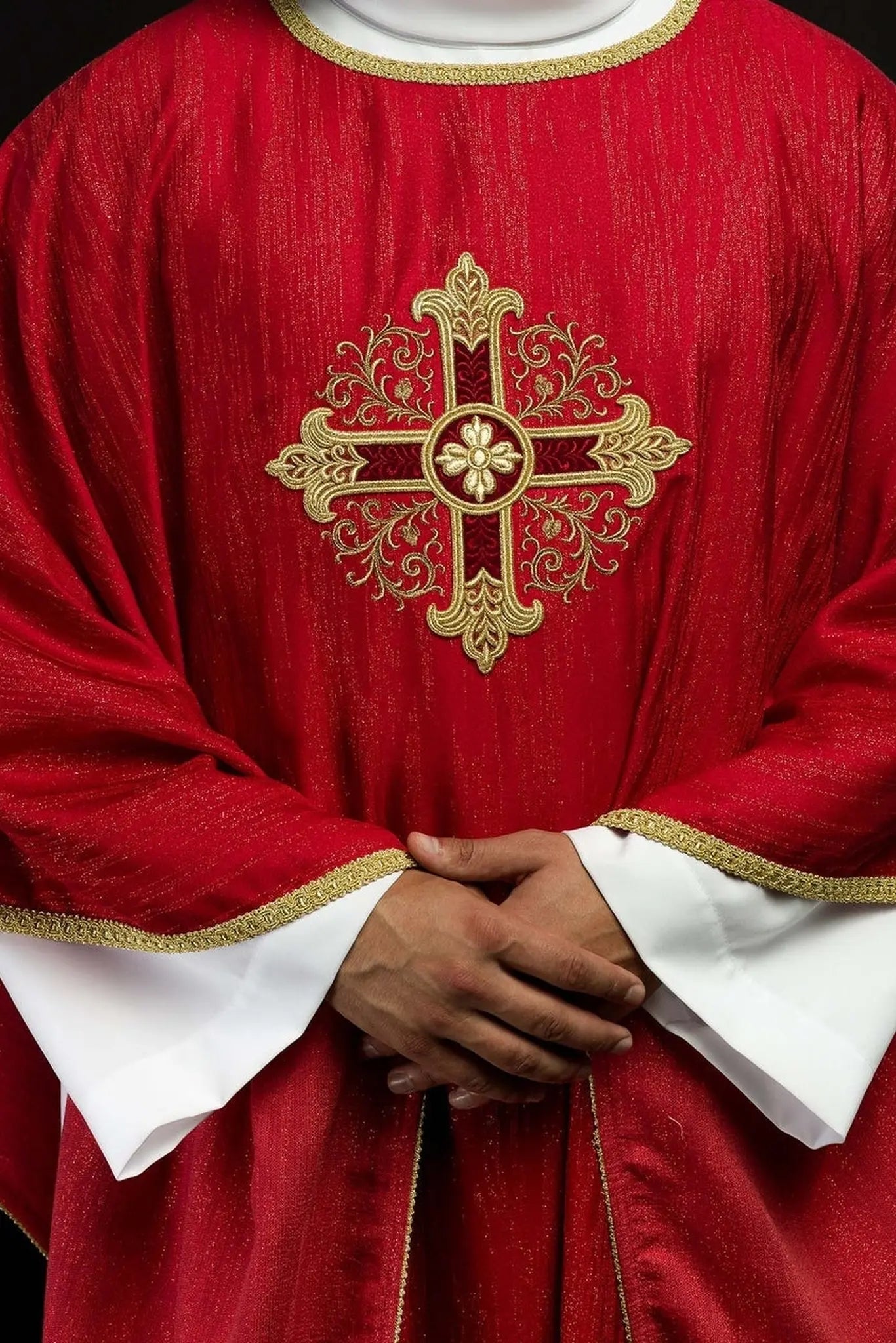 Red chasuble with embroidered cross motif on decorative fabric