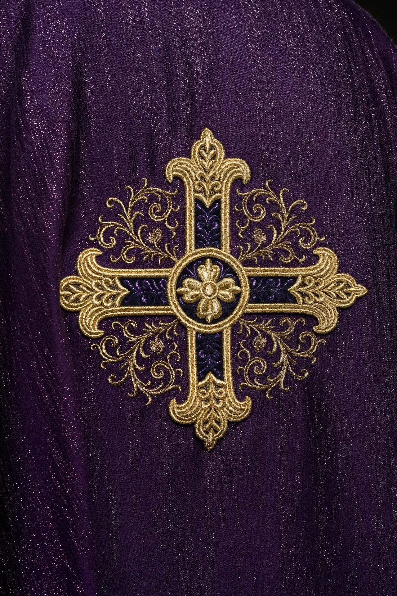 Purple liturgical chasuble with an embroidered cross motif on decorative fabric