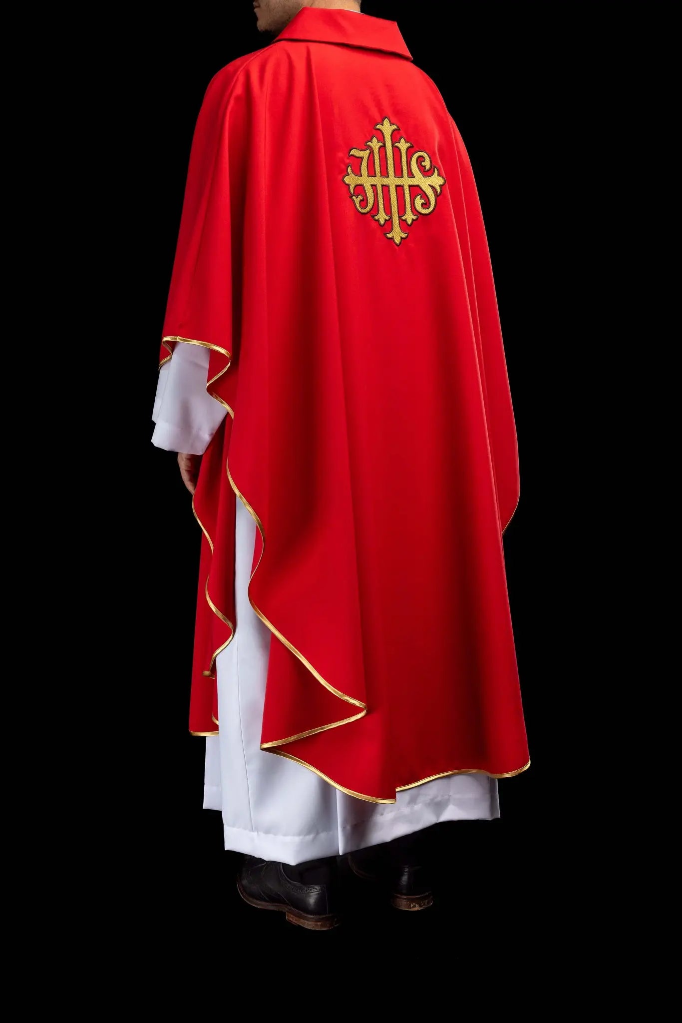 Red chasuble with gold IHS embroidery on the front and back, finished with gold trim and a V-neckline.