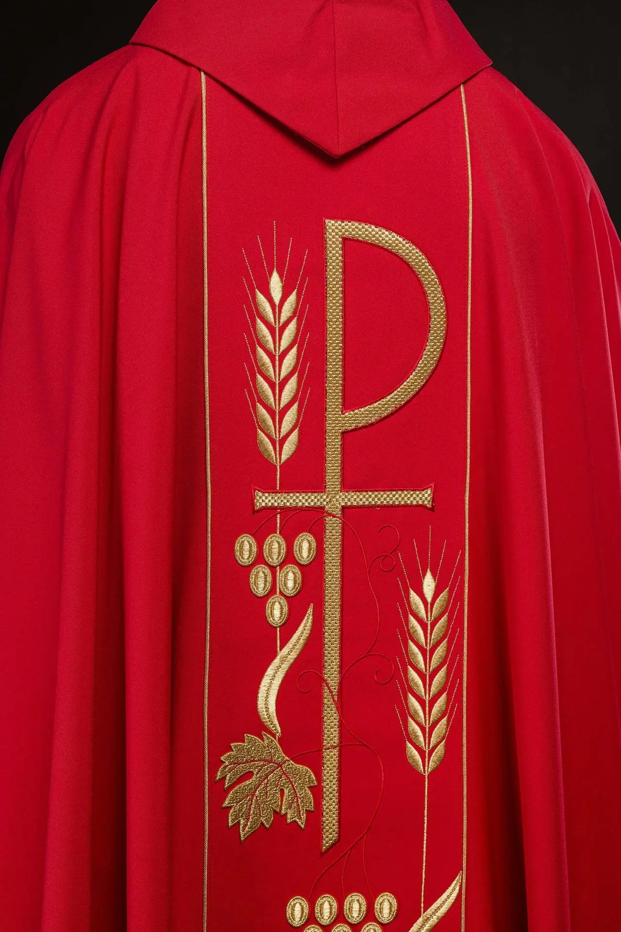 Red chasuble embroidered with IHS chalice design