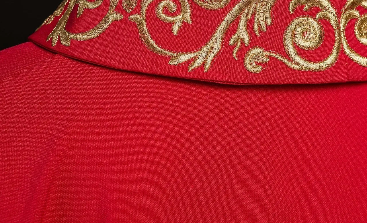 Red chasuble with gold IHS embroidery and decorative trim