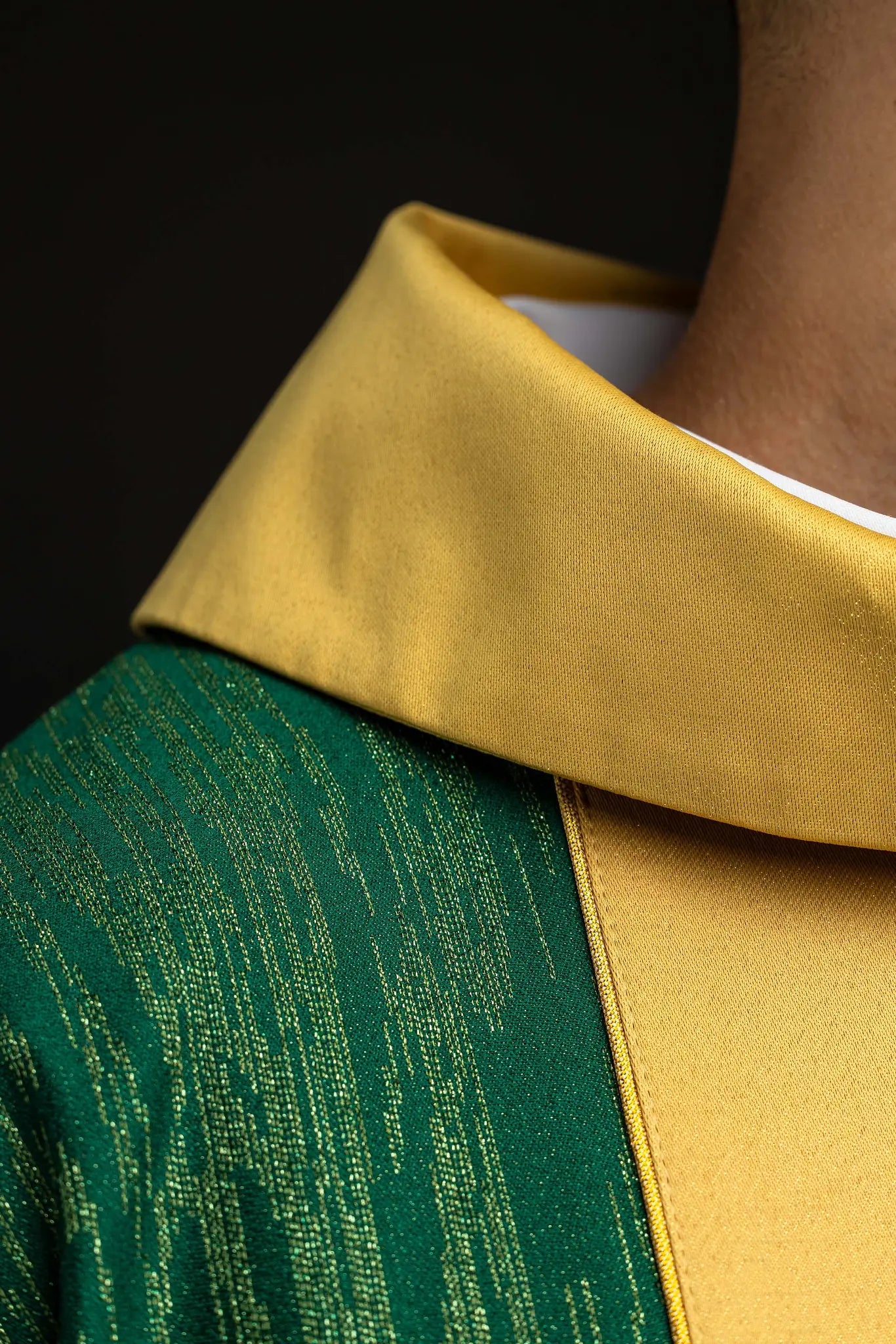 Green chasuble with a vertical gold band featuring embroidered crosses, gold trim on edges and collar, and a stand-up collar.