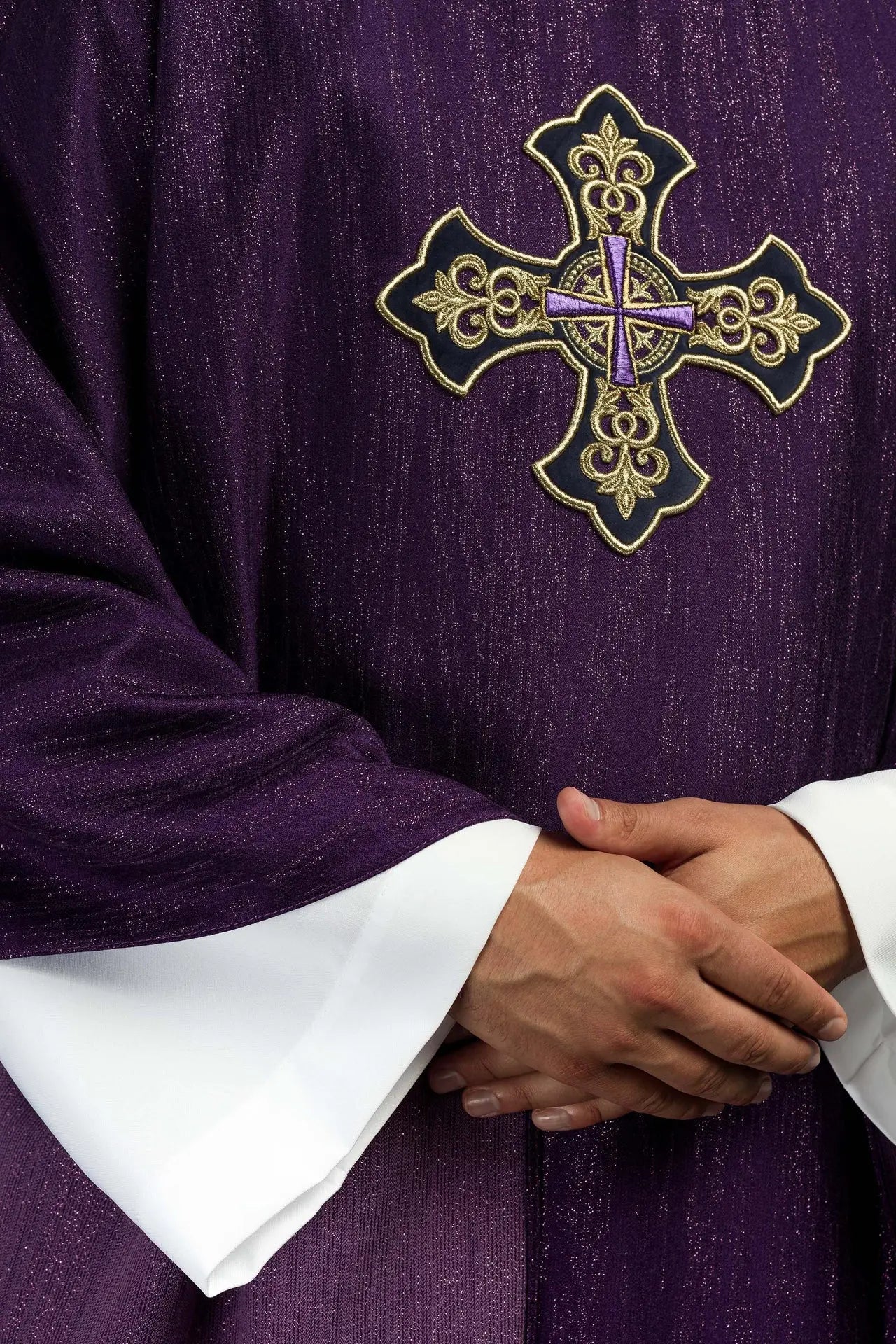 Purple chasuble with embroidered cross motif on de