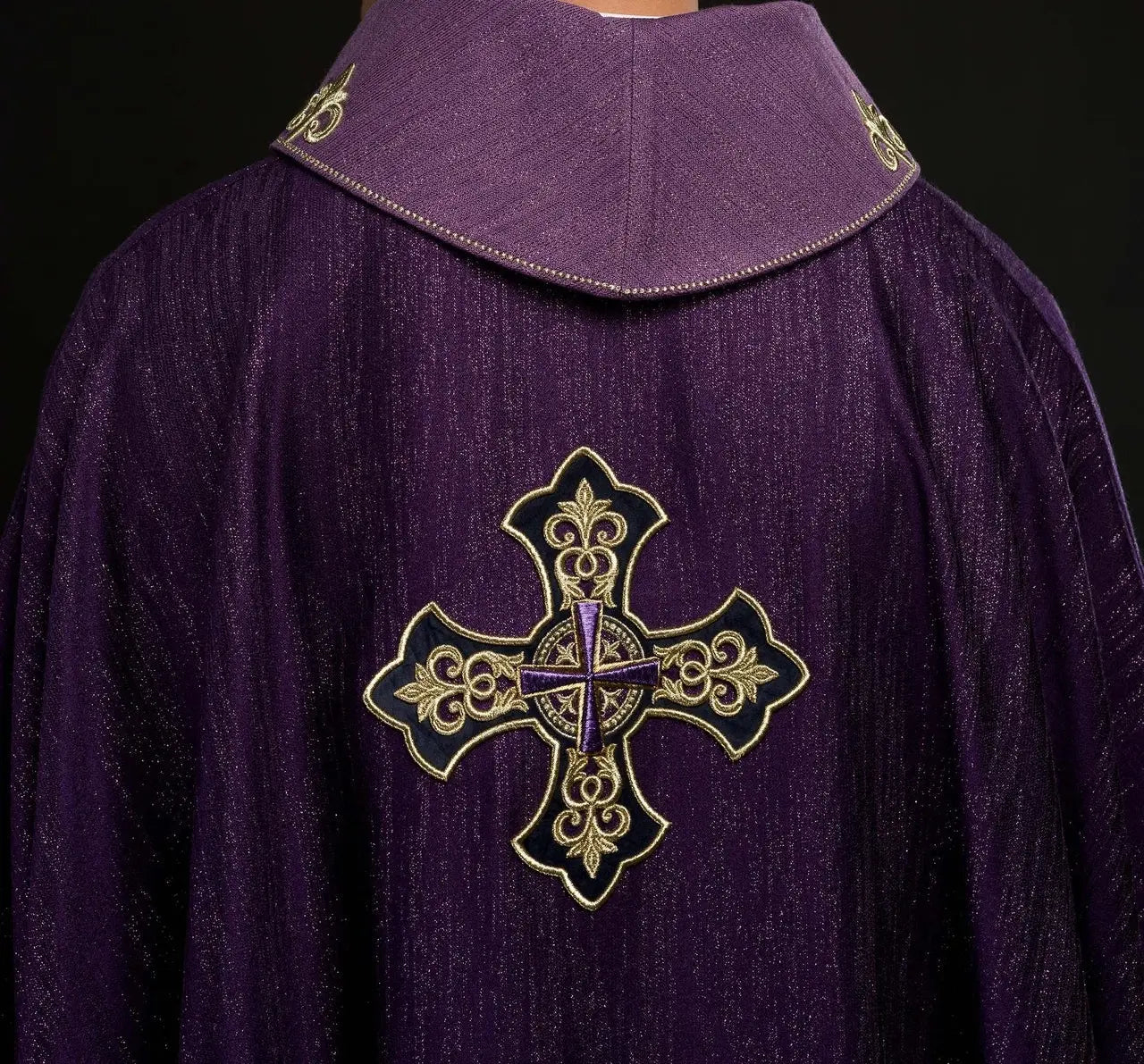 Purple chasuble with embroidered cross motif on de