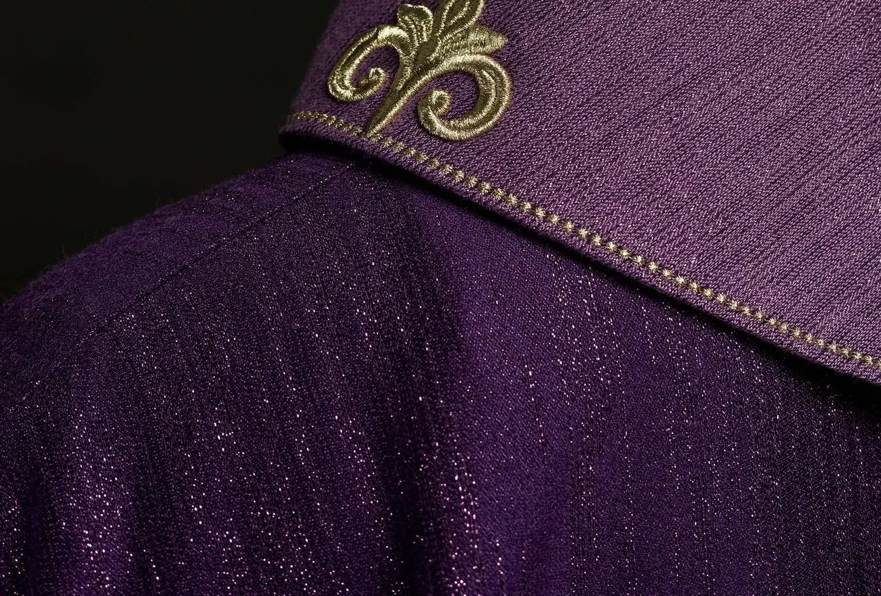 Purple chasuble with embroidered cross motif on de