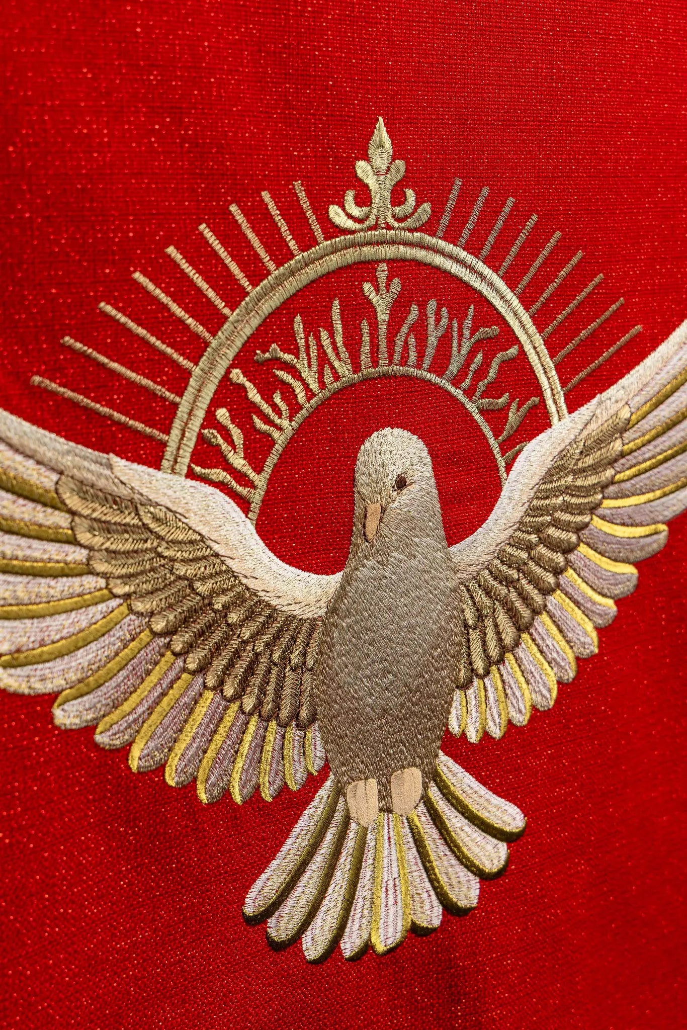 Red lectern hanging with embroidered Dove of the Holy Spirit and rays, finished with gold fringes.