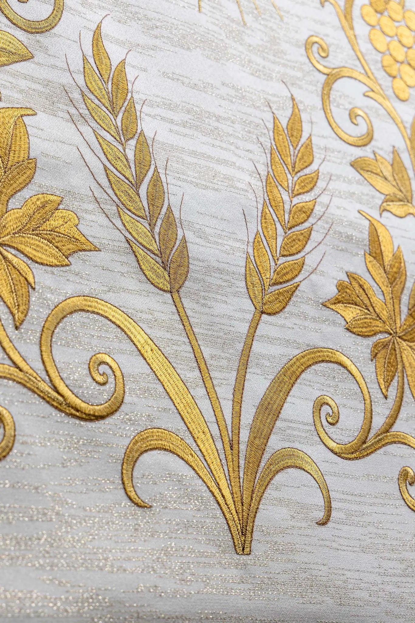 Ecru lectern cover with rich gold IHS monogram embroidery, radiant glory, wheat sheaves, and grapevines, finished with gold fringes.