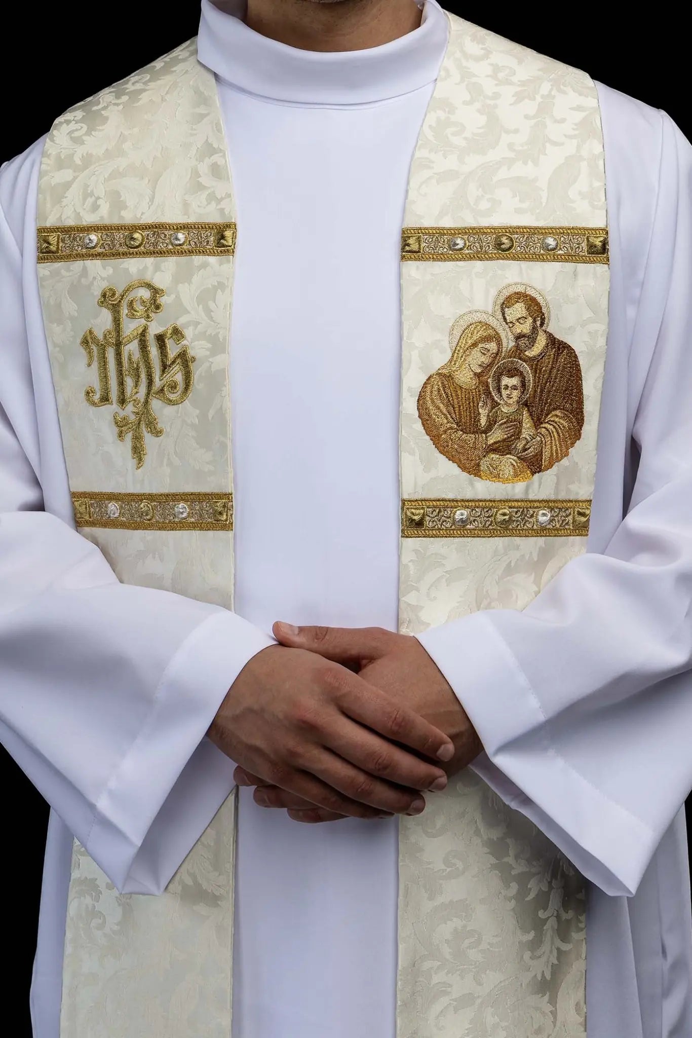 Ecru stole with Holy Family image on one side and IHS monogram on the other, featuring gold trim and tassels.
