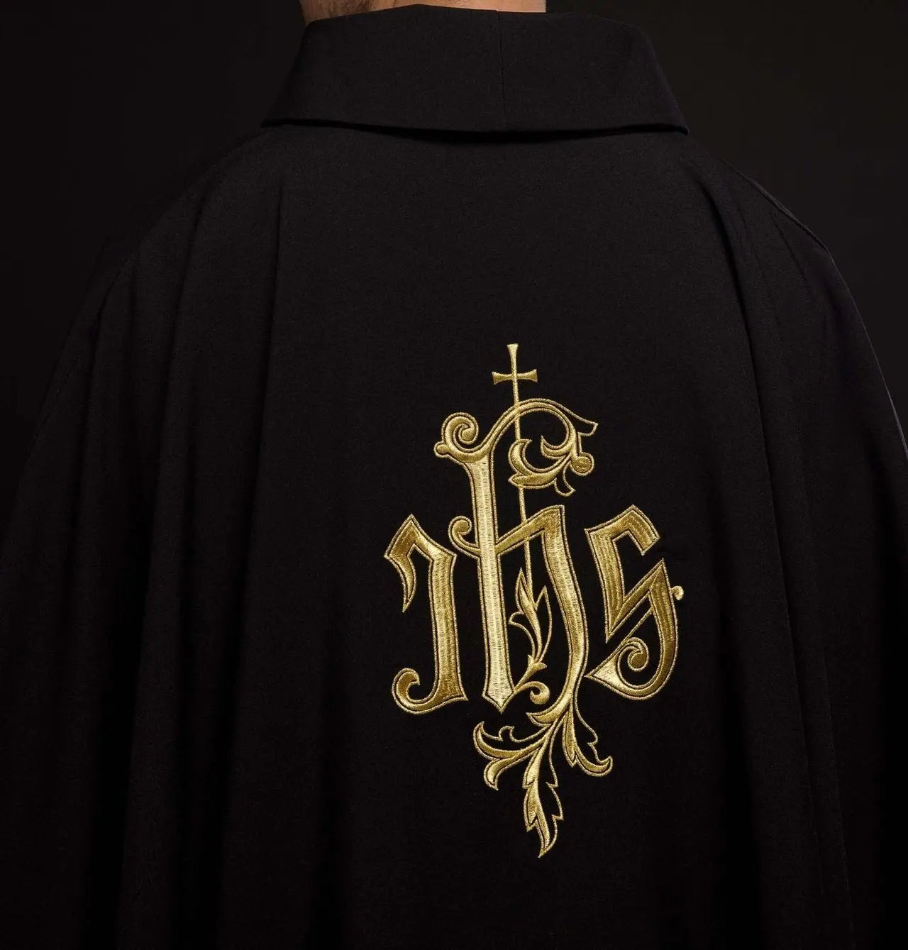 Black chasuble embroidered with IHS