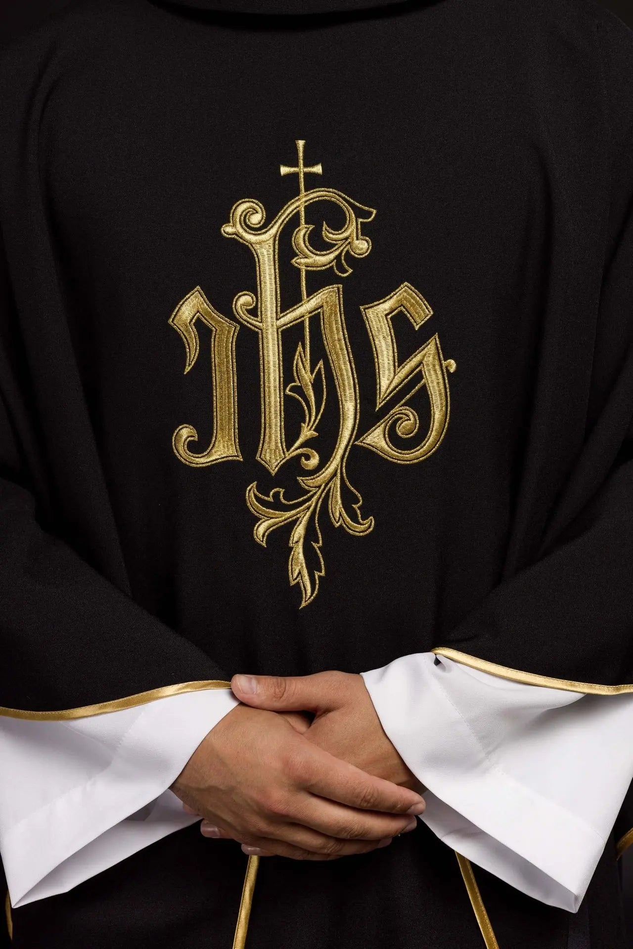 Black chasuble embroidered with IHS
