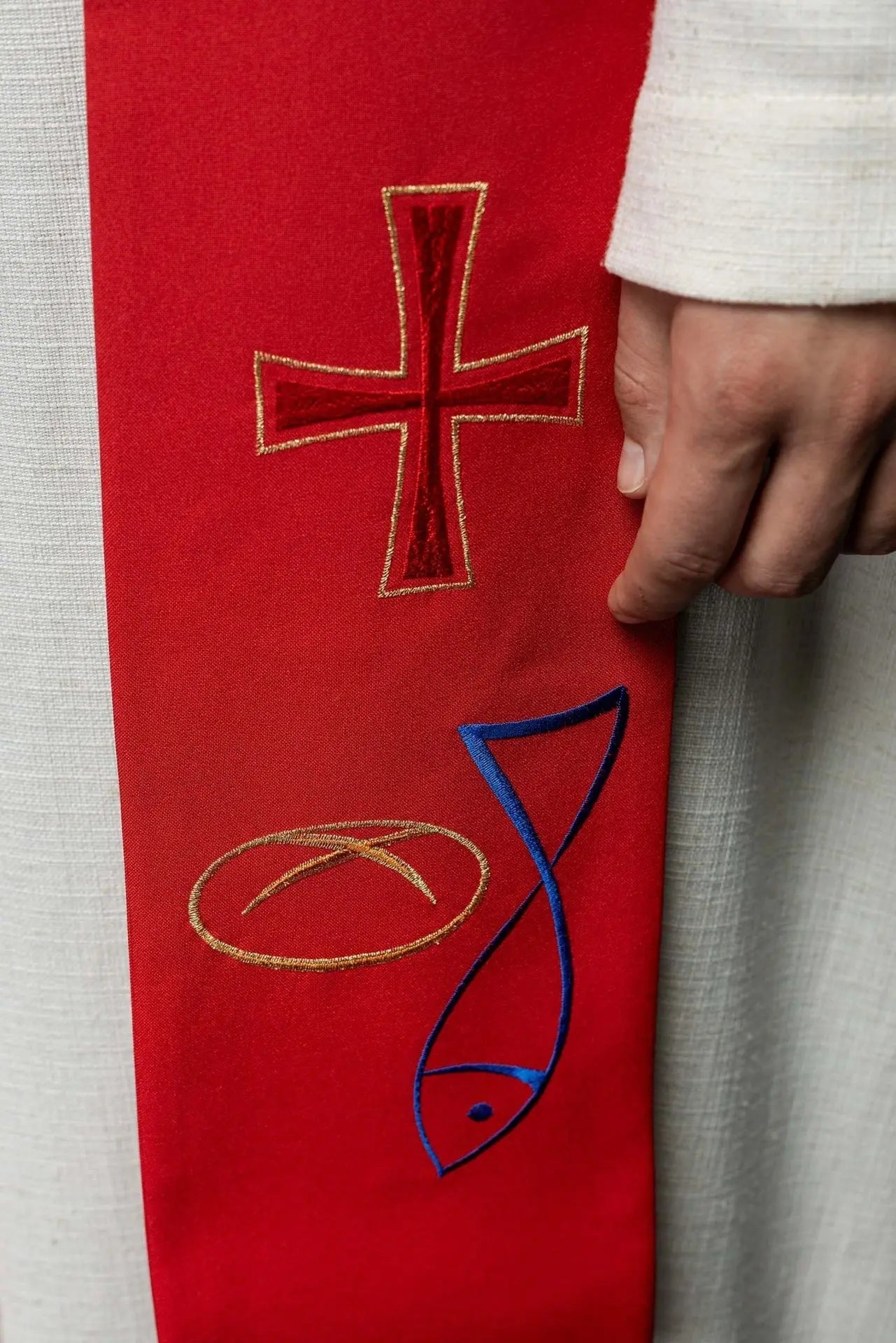 Red embroidered priest's stole with Fish Bread Cross motif