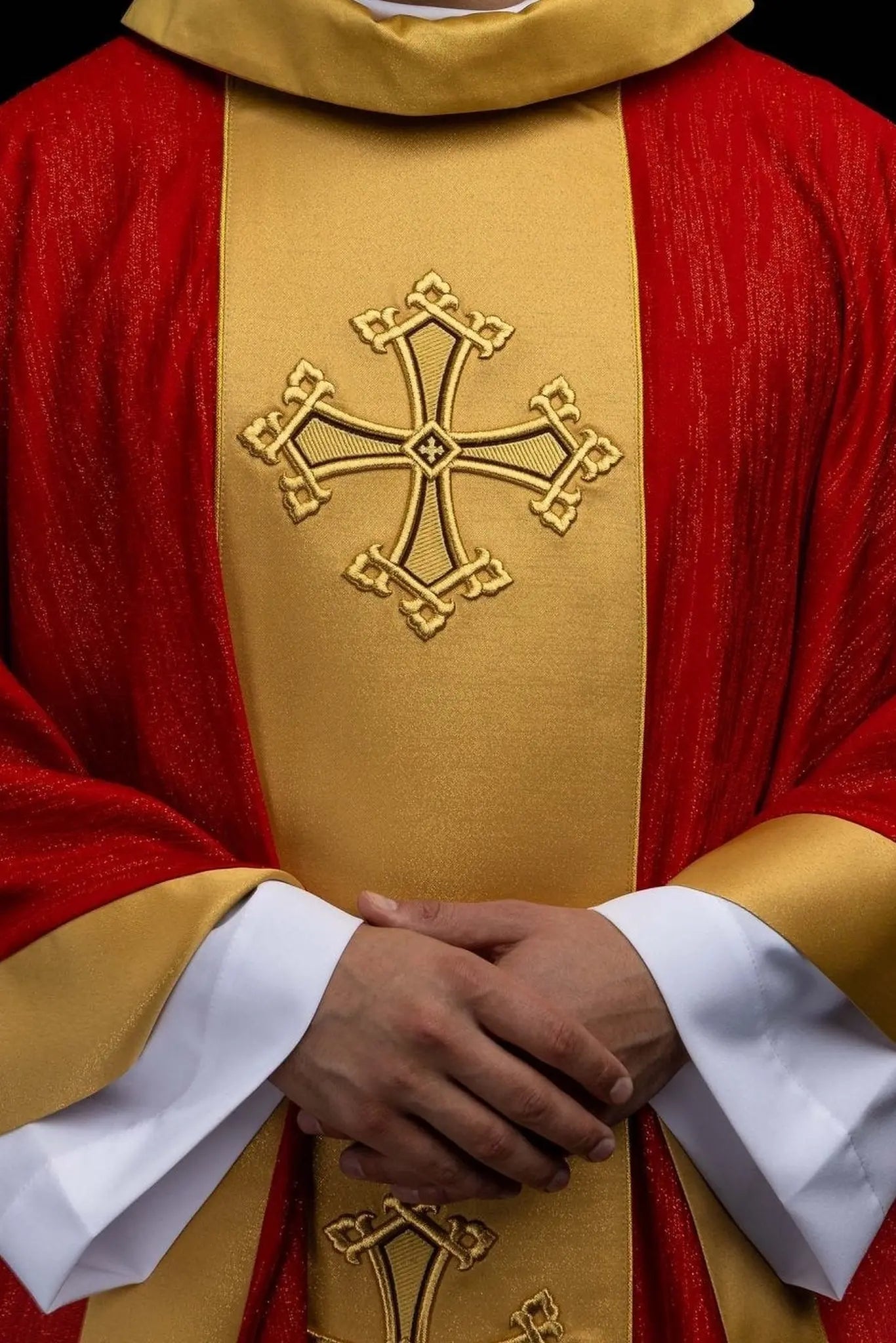 Red chasuble with embroidered cross motif and decorative gold band