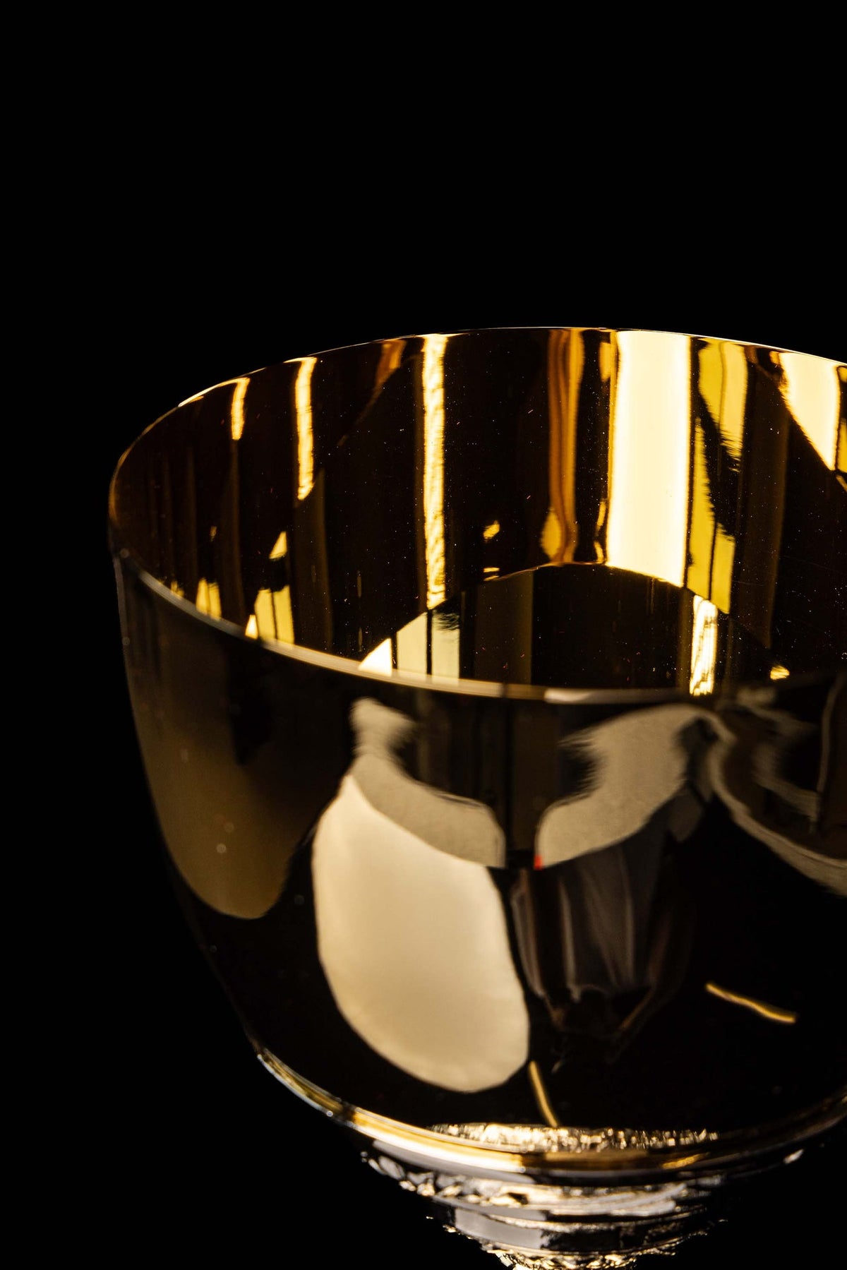 Gold and silver chalice with relief plant motifs, close-up of cup and plant band