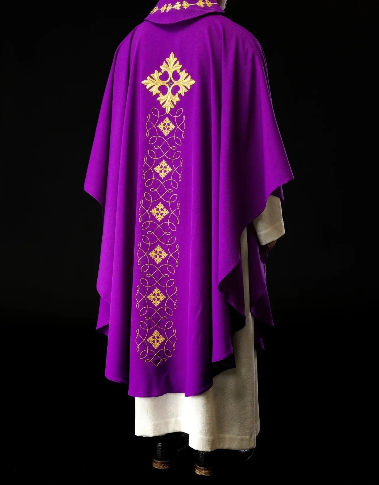 Purple chasuble richly embroidered with string and stones