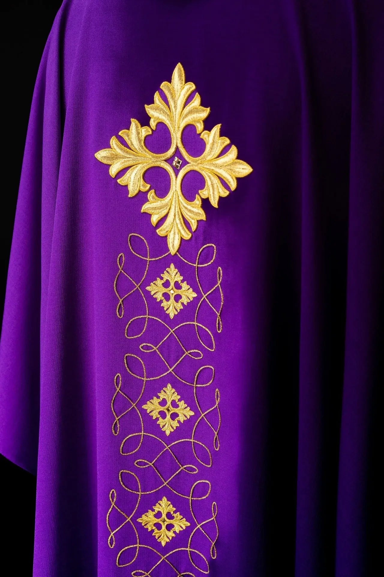 Purple chasuble richly embroidered with string and stones