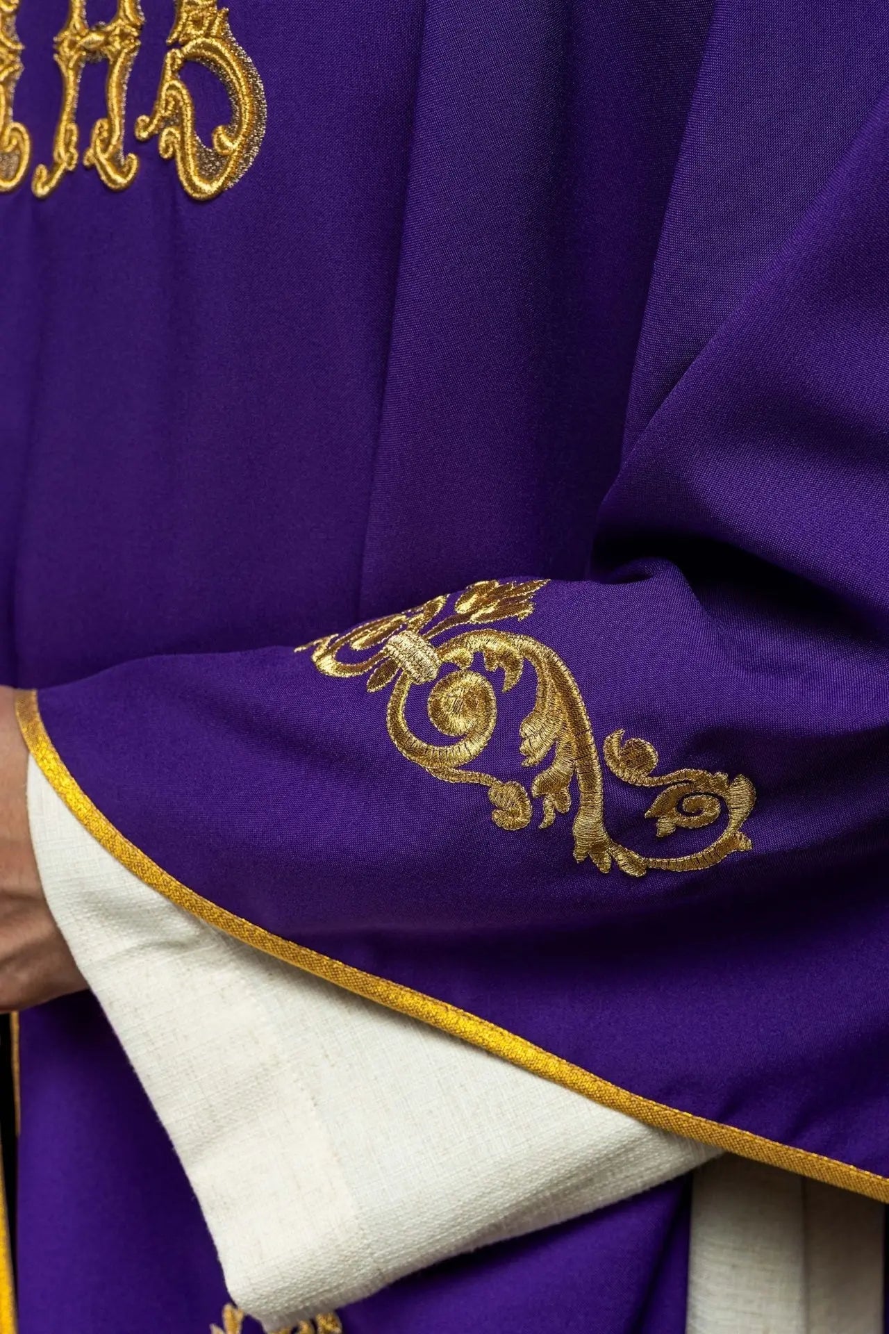 Purple chasuble with gold IHS embroidery and decorative trim