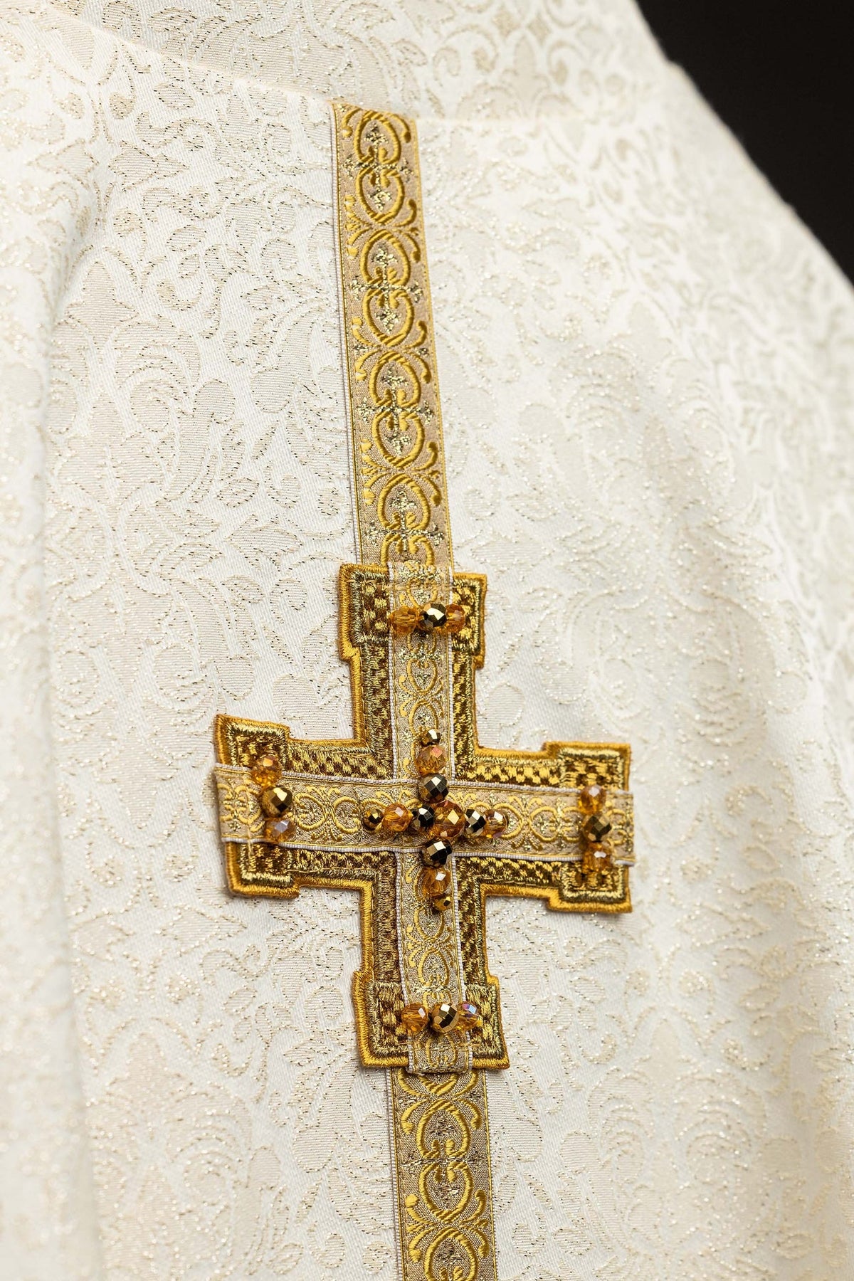 Ecru chasuble with dimensional crosses and natural stones, close-up front view