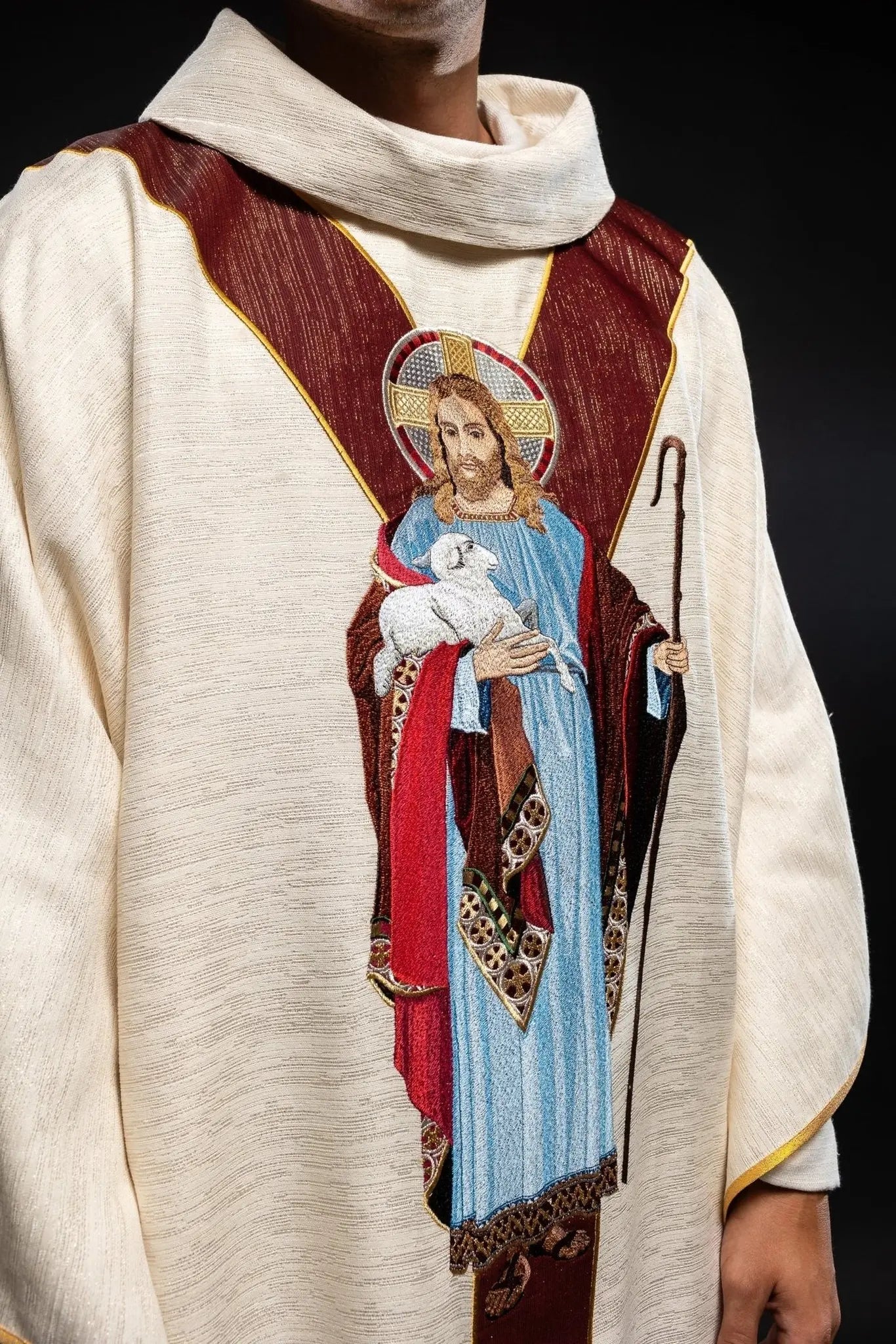 Chasuble ecru with the image of Jesus the Good Shepherd with a decorative burgundy stripe
