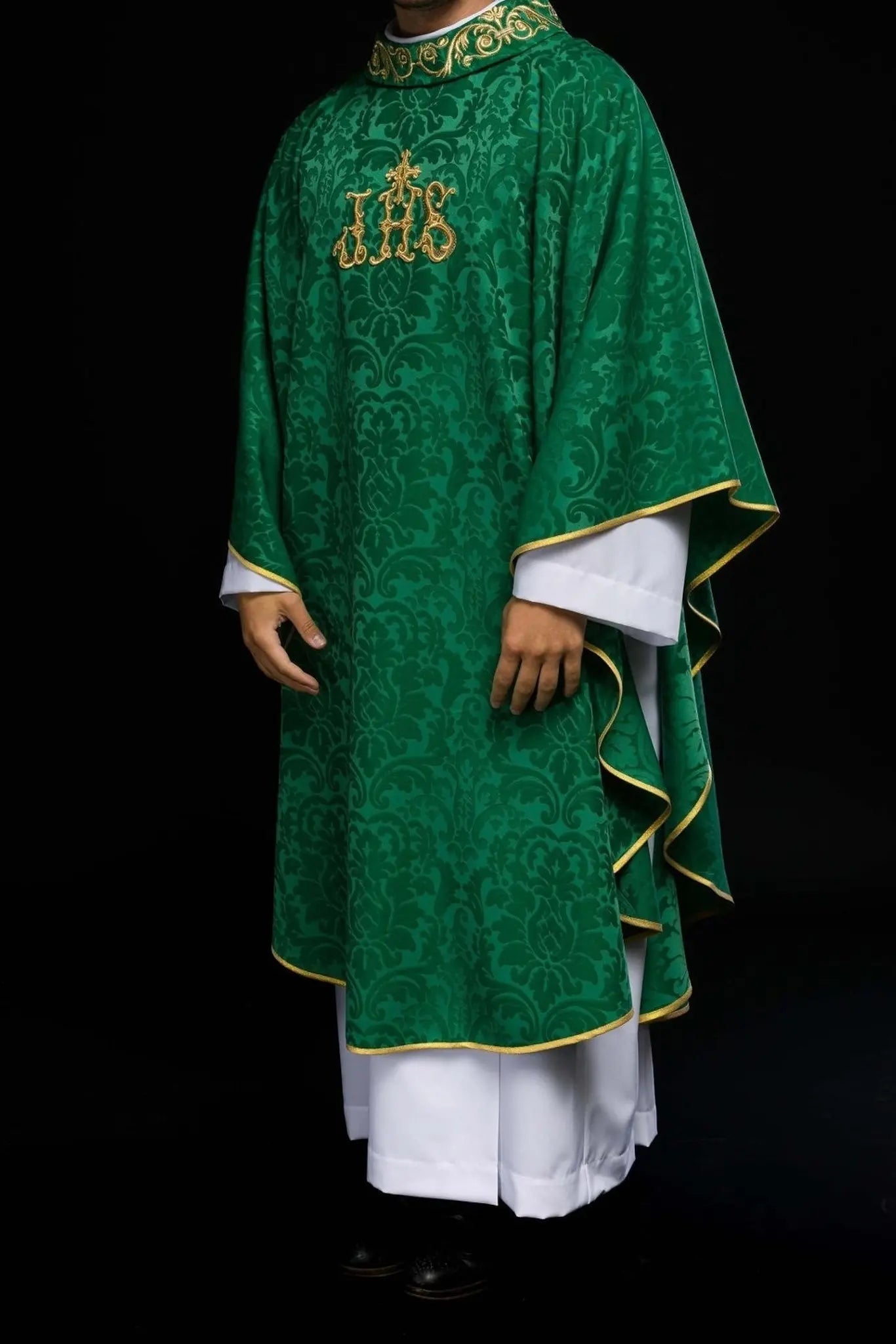 Green chasuble with IHS motif and richly embroidered collar on decorative fabric