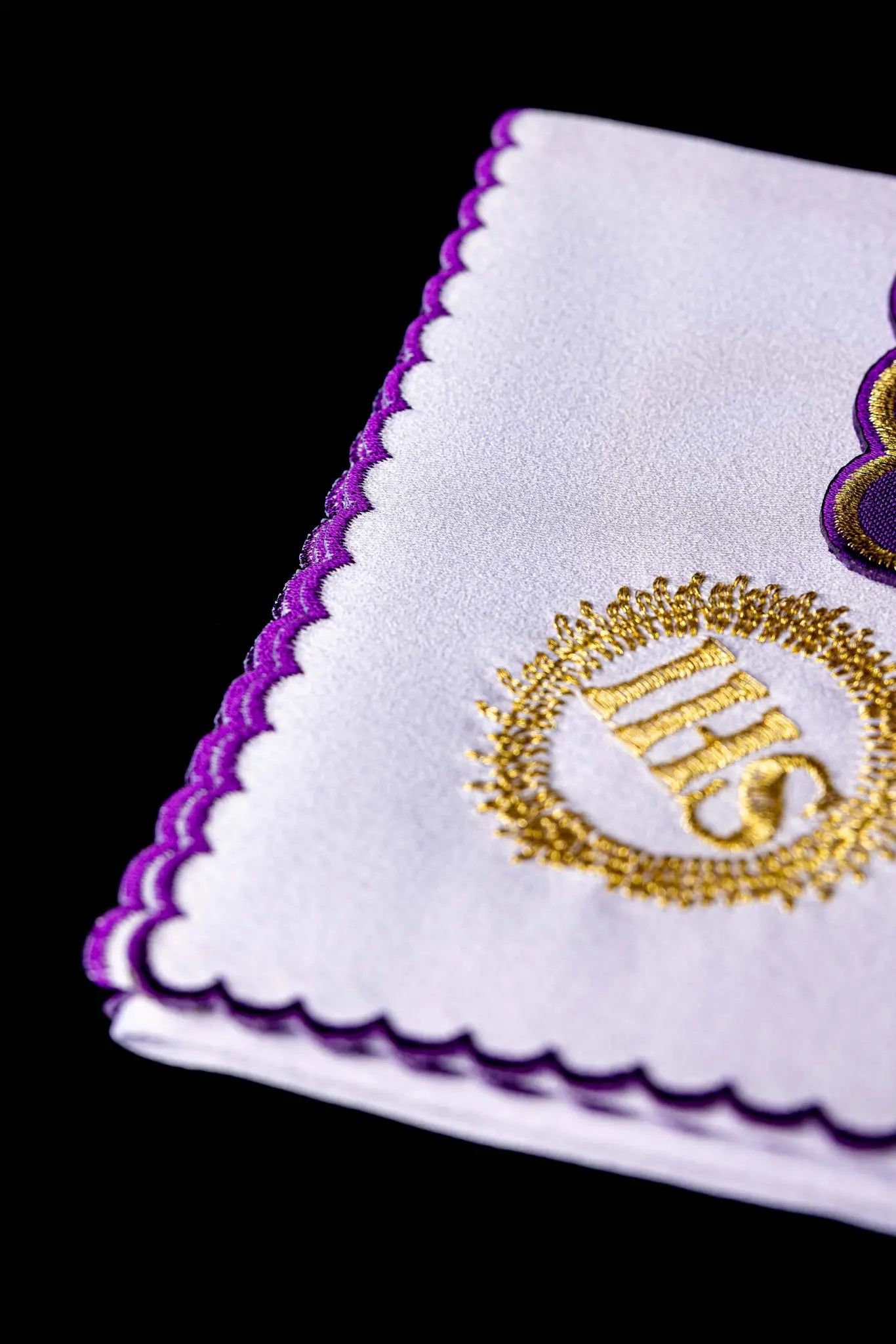 Purple chalice linen set with gold IHS embroidery on pall, corporal, purificator, and lavabo towel