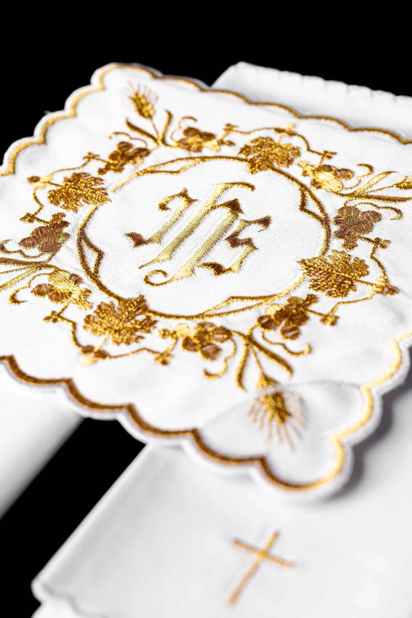 White chalice linen set with IHS embroidery on pall, purificator, and lavabo towel.