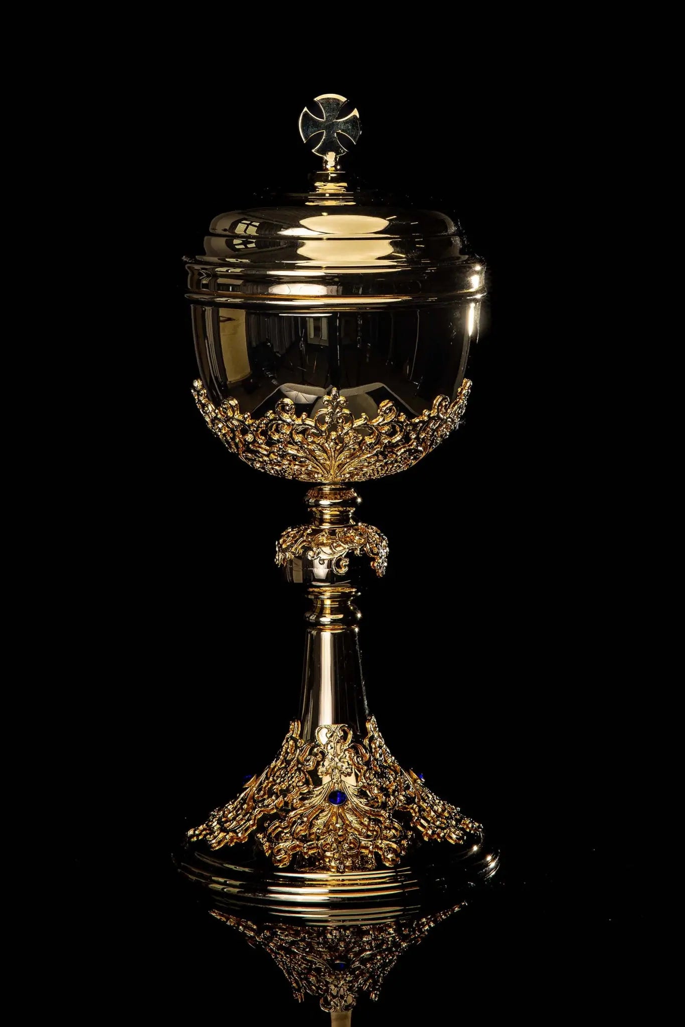 Handmade gold-plated ciborium with floral ornamentation and blue imitation sapphires, topped with a cross.