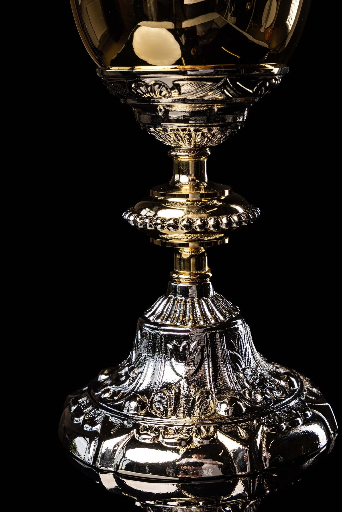 Gold and silver chalice with relief plant motifs, close-up of stem and base