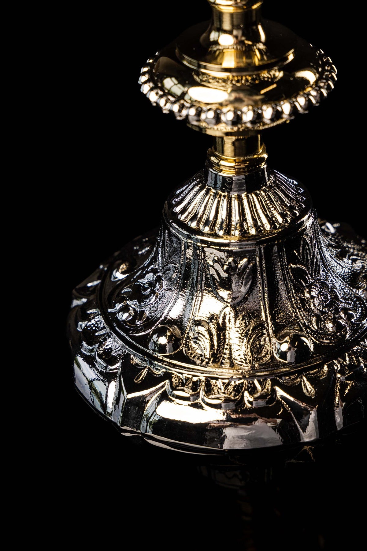 Gold and silver chalice with relief plant motifs, close-up of lower cup and stem