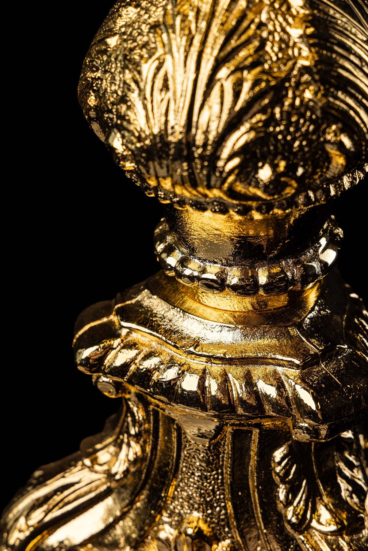 Gold-plated brass monstrance with radiant rays of Christ's Glory, ornate base close-up