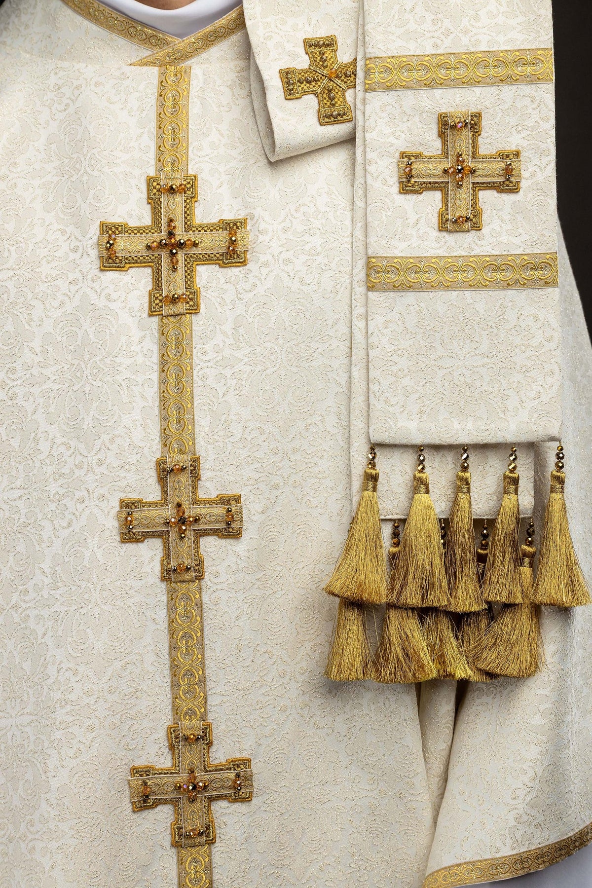 Ecru chasuble with dimensional crosses and natural stones, cross and tassel detail