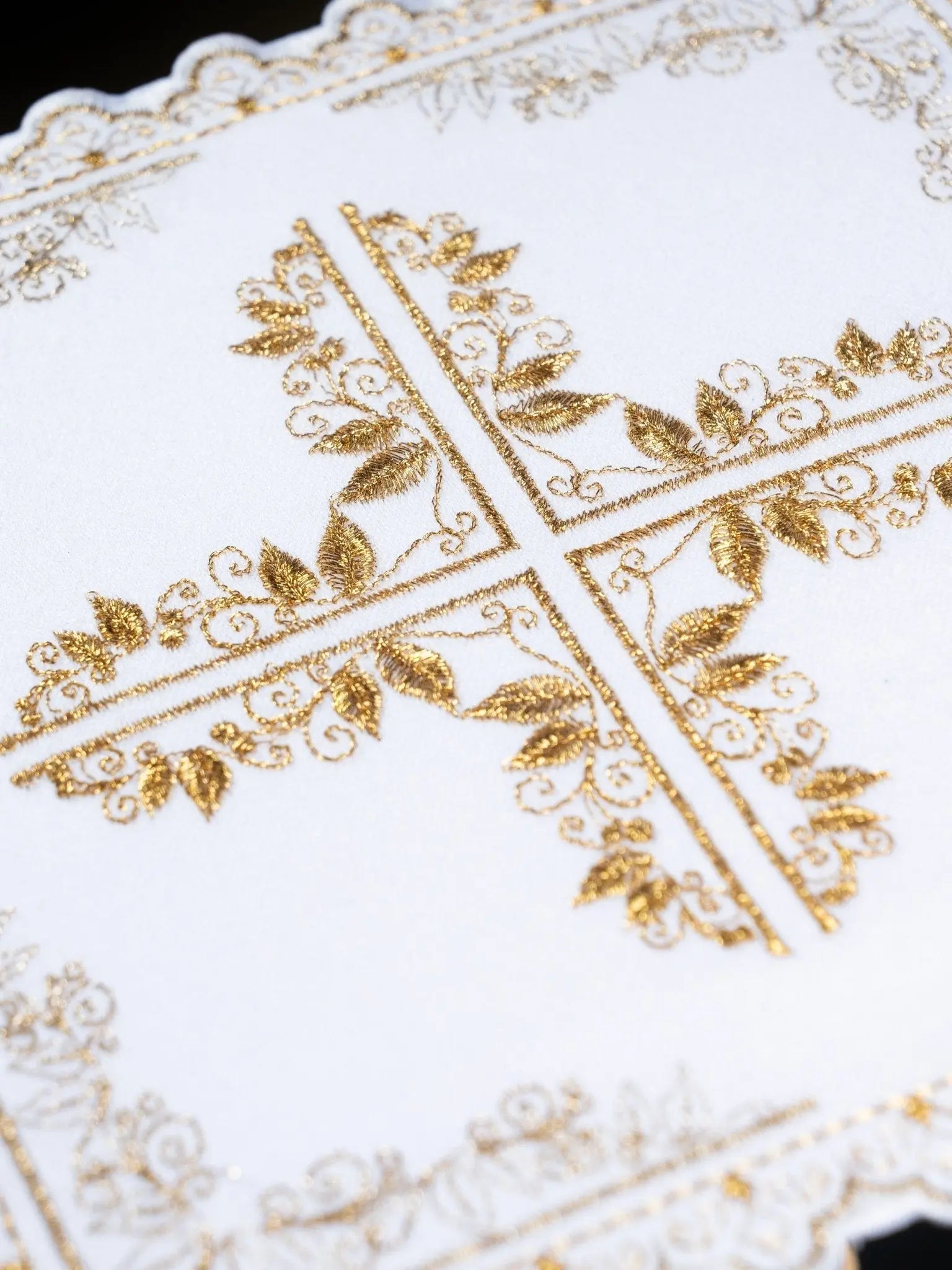 Linen cup set with cross motif framed by floral embroidery