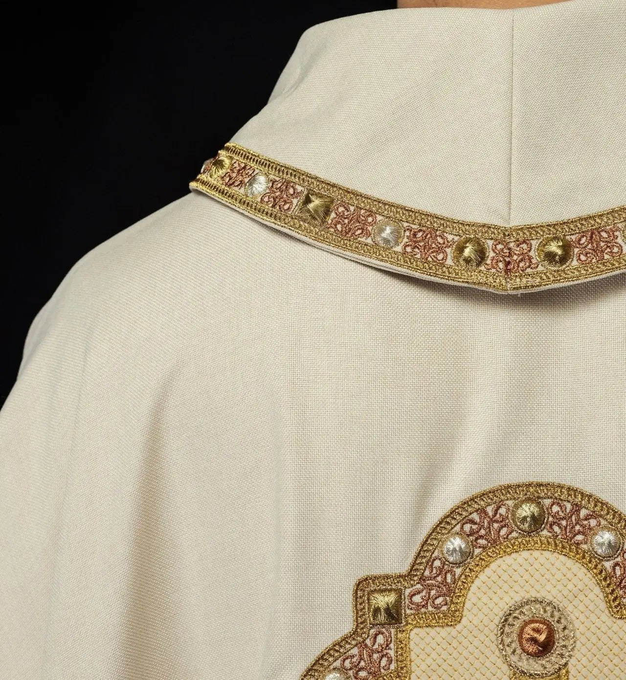 Chasuble de couleur écrue avec bordure brodée sur le col et autour de la broderie de la croix