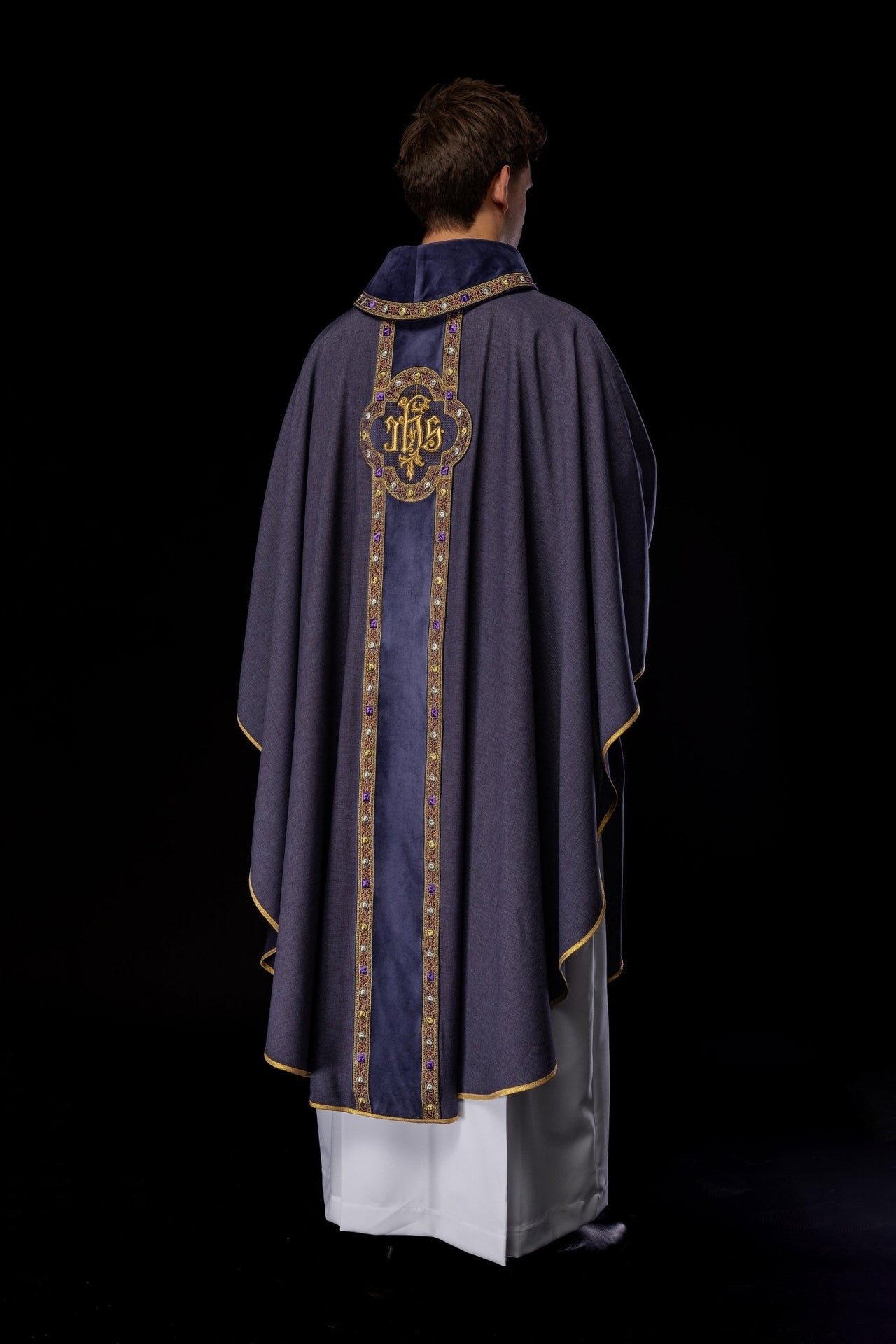 Ornat z bogato haftowanym pasem i lamówką wokół haftu IHS i kołnierza w kolorze fioletowym