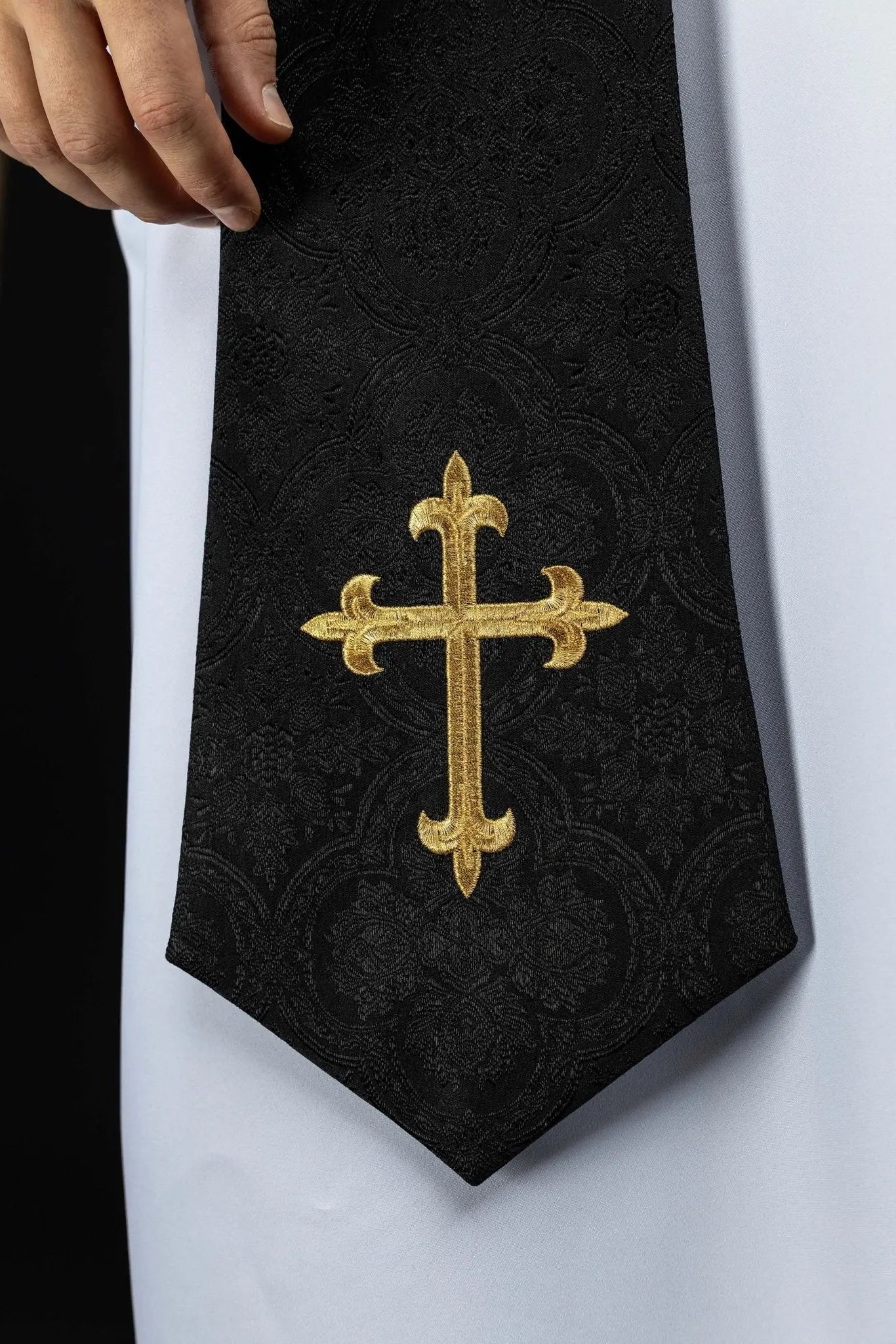 Black jacquard stole with embroidered gold crosses for liturgical use.